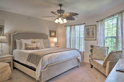 a bedroom with a bed and a fan and a chair at Stylish Resort Condo 3 Mi to Downtown Branson! in Branson
