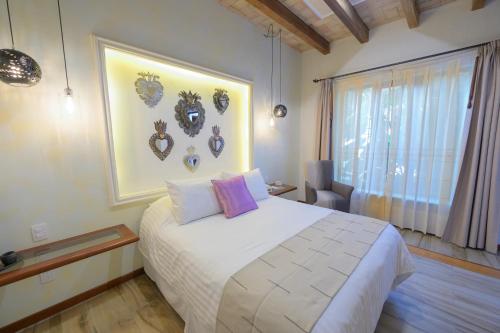 a hotel room with a large bed and a large window at Hotel Casa Vertiz in Oaxaca City