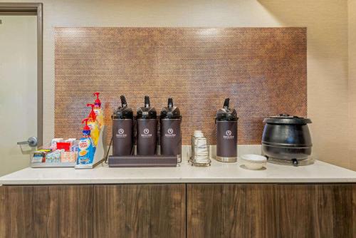 a counter with bottles of alcohol on top of it at La Quinta by Wyndham Jamestown in Jamestown