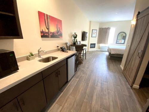 a kitchen with a sink and a living room at Sedona Village Lodge in Sedona