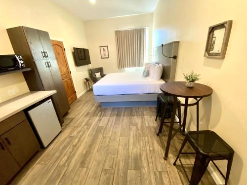 a hotel room with a bed and a table at Sedona Village Lodge in Sedona