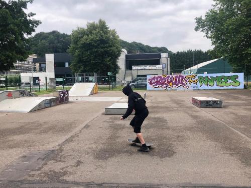 a person riding a skateboard in a skate park at HOME SWEET HOME in the green lung of Brussels in Hoeilaart