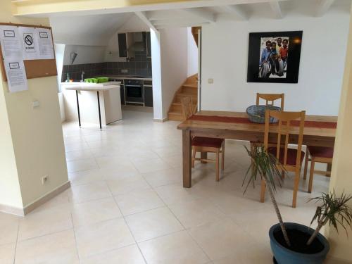 a kitchen and dining room with a table and chairs at HOME SWEET HOME in the green lung of Brussels in Hoeilaart