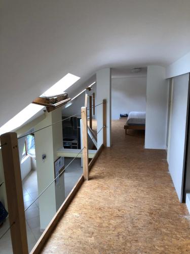 a room with a staircase and a bed in it at HOME SWEET HOME in the green lung of Brussels in Hoeilaart