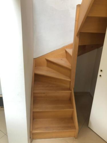 a staircase in a house with wooden steps at HOME SWEET HOME in the green lung of Brussels in Hoeilaart