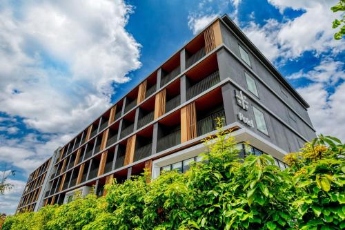 an office building with red and white windows at Umekoji Potel KYOTO in Kyoto