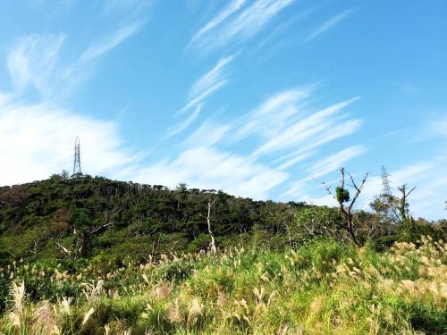 a hill with a radio tower on top of it at Saraswati in Nakijin