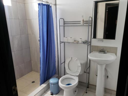 a bathroom with a toilet and a sink and a shower at Casa cerca de Estero Beach in Ensenada