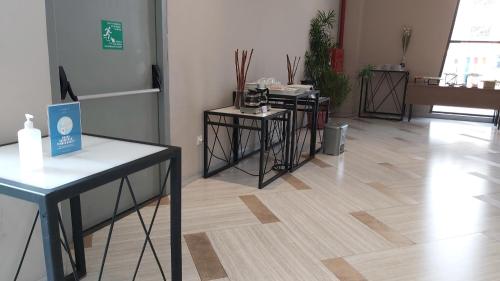 a room with two tables and a wooden floor at Luminor Hotel Jakarta Kota By WH in Jakarta