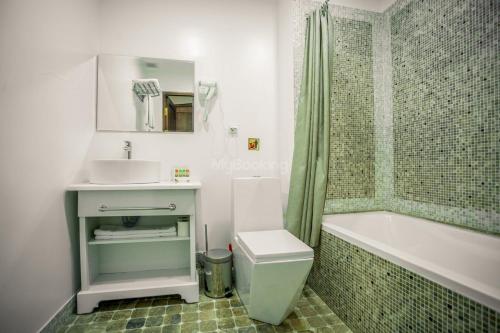 a bathroom with a sink and a toilet and a tub at Boutique DEVON in Bukhara