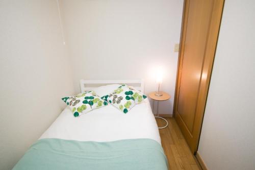 Ένα ή περισσότερα κρεβάτια σε δωμάτιο στο Atami Ajiro House貸切温泉宿