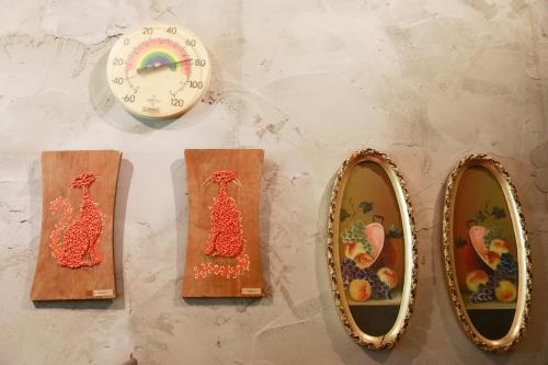 a clock and two wooden cutting boards and a clock at Pension Kamifuji in Osaki