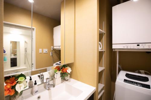 a bathroom with a sink and a mirror at Ocean Resort House 205 in Onna