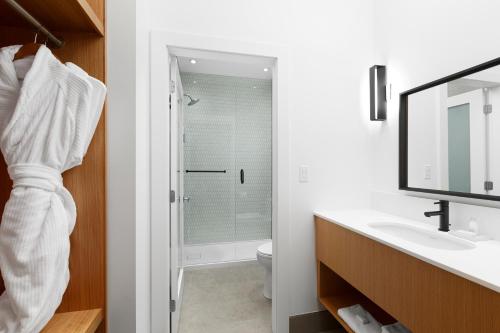 a bathroom with a shower and a sink at Victorian Hotel in Vancouver