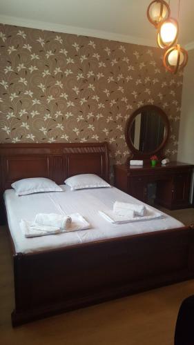 a bedroom with a bed with two towels on it at Guesthouse different in Tbilisi City