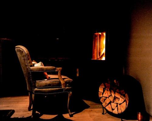 a dark room with a chair and a lamp at Luxury Grimentz Apartment in Grimentz