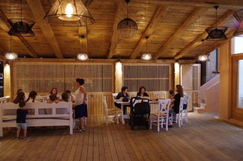 a group of people sitting at tables in a room at Lygaria Studios in Agia Pelagia