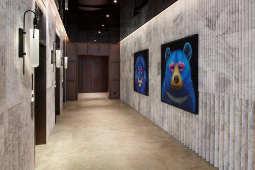 a hallway with two paintings of a bear on the wall at Mondrian Seoul Itaewon in Seoul