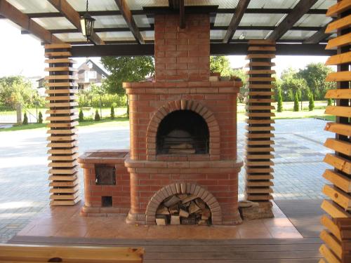 a brick pizza oven sitting on a patio at Hotel in Kraslava in Krāslava
