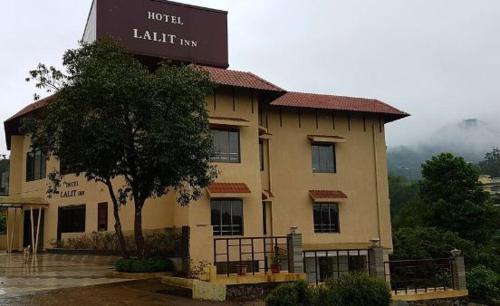 a large building with a sign in front of it at Hotel Lalit Inn in Khandala