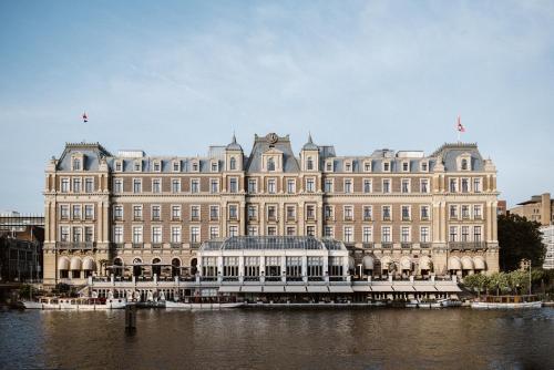 a large building with a large clock tower in front of it at InterContinental Amstel Amsterdam, an IHG Hotel in Amsterdam