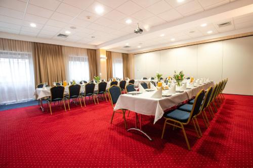 a conference room with tables and chairs in it at Business Hotel Vega Wrocław in Wrocław