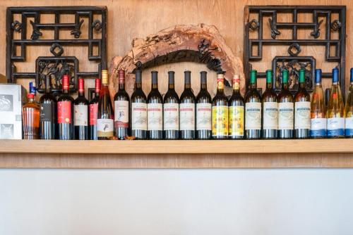a bunch of bottles of wine sitting on a shelf at Ridge Inn in Longsheng