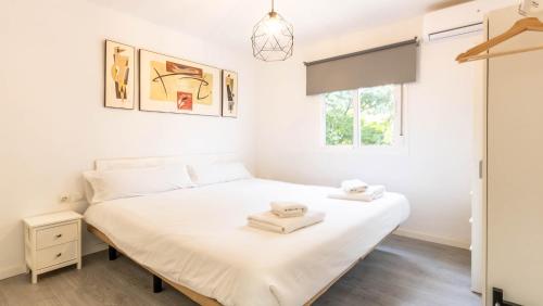 1 dormitorio con cama blanca y ventana en Apartamento Santa Justa, en Sevilla