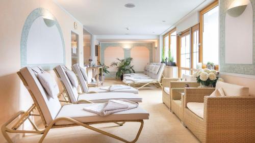 a salon with a row of chairs and a mirror at Hotel Auhof Kappl in Kappl