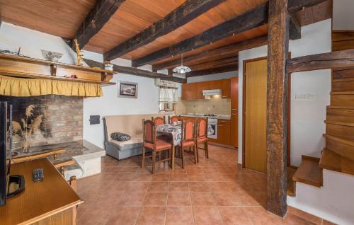 a kitchen and dining room with a table and chairs at Apartments Petina in Pićan