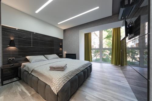 a bedroom with a large bed and a large window at Luxrent Kreshatik Arenacity SkyBar in Kyiv