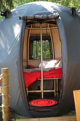 a small tent with a bed in it at Palapinė medyje in Barkellai