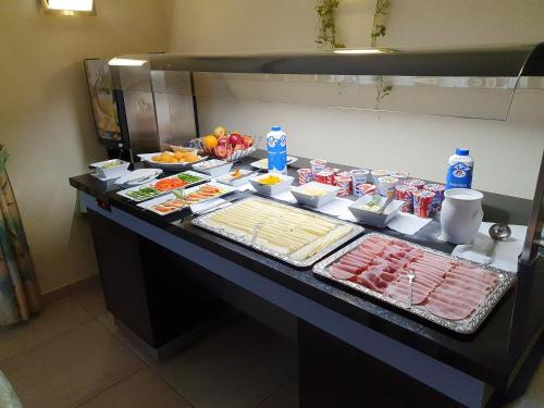 a buffet with meat and other foods on a table at Gasthof Hotel Zur Post in Ferlach