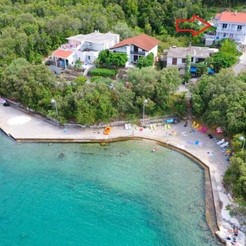 an aerial view of a beach with chairs and umbrellas at Apartments Vesela in Janjina