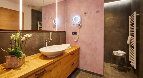 a bathroom with a sink and a mirror at Landhotel zum Bad in Krün