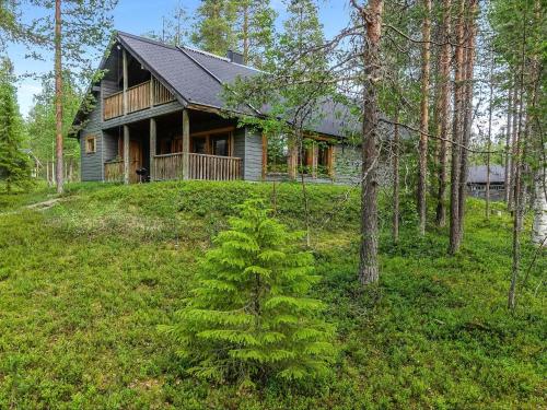 a small pine tree in front of a house at Holiday Home Sakumaja by Interhome in Levi