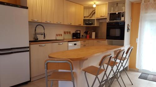 a kitchen with wooden cabinets and a wooden counter top at Maison avec vue in Les-Pennes-Mirabeau