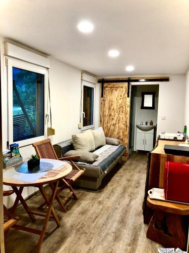a living room with a couch and a table at Skalca in Kamniška Bistrica
