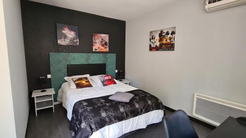 a bedroom with a bed and a chair in it at ALYSA in Parthenay