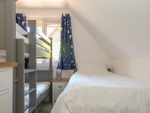 a bedroom with two bunk beds and a window at 32 Trevithick in Hayle