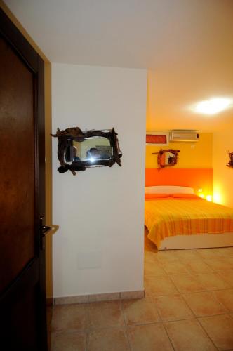 a bedroom with a bed and a mirror on the wall at Il Sogno di Alghero - Adults Only in Alghero
