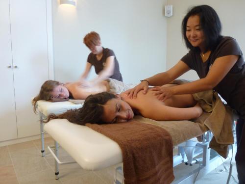 a woman laying on a bed in a massage room at Monnàber Vell in Campanet