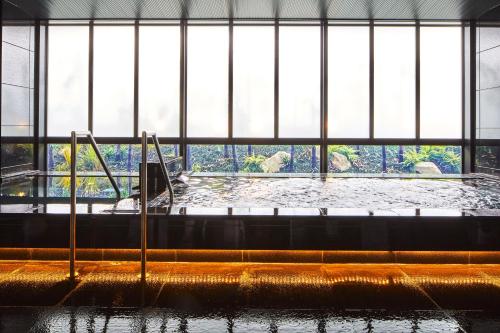 a large room with a pool of water with elephants in it at Hotel Emion Kyoto in Kyoto