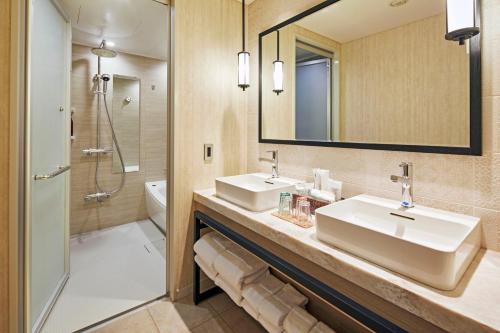 a bathroom with two sinks and a mirror at Hotel Emion Kyoto in Kyoto