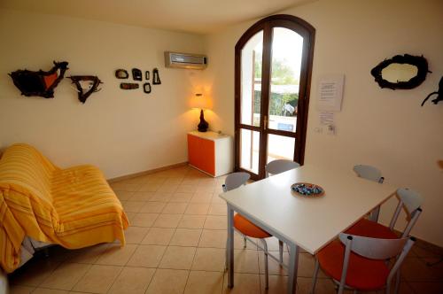 a room with a table and chairs and a window at Il Sogno di Alghero - Adults Only in Alghero