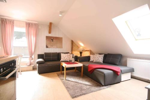 a living room with a couch and a table at Almliesl Gruppenhaus PUCH-625 in Puchenstuben