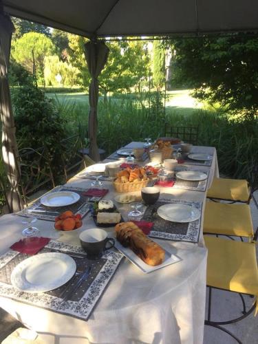 a long table with food on top of it at Le Mas d'Hermès in Plan-dʼOrgon