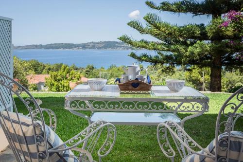 a white table with a tea pot on top of it at Panorama Fanari studios and apartments in Argostoli