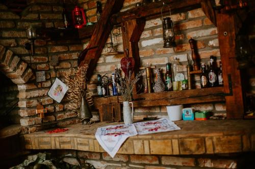 a stone wall with a counter in a room with a fireplace at Lavanda in Vukovar