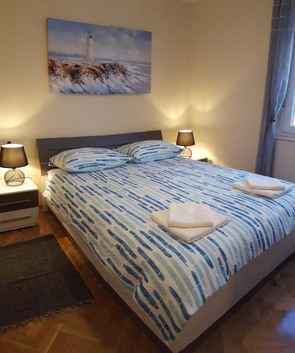 a bedroom with a bed with two pillows on it at Harmony apartment in Rijeka